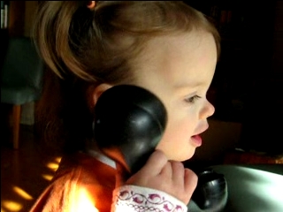 Peo plays with a phone
