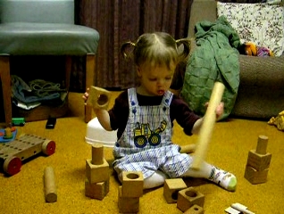Peo playing with wooden blocks and pegs.