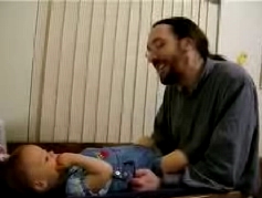 Daddy smiling at Peo on change table