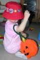 Child Playing with Pumpkin Bag - View 1